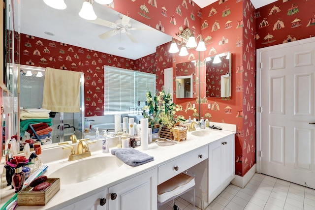 bathroom featuring ceiling fan, vanity, a bath, and tile patterned floors