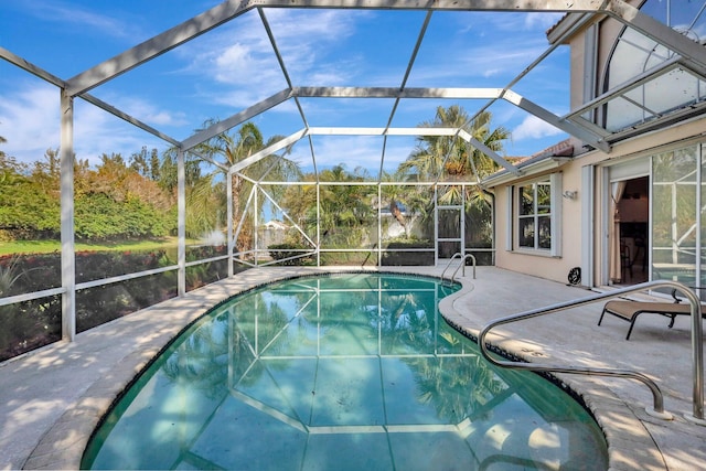 view of swimming pool featuring a patio and glass enclosure