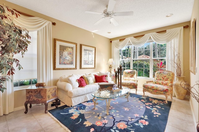 tiled living room with ceiling fan and a textured ceiling