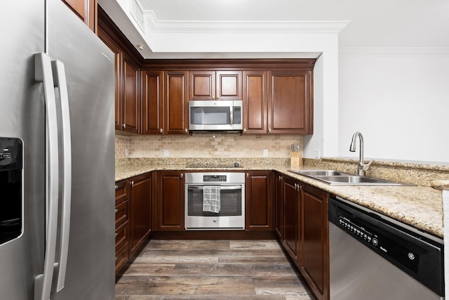 kitchen featuring dark hardwood / wood-style floors, sink, light stone countertops, stainless steel appliances, and ornamental molding