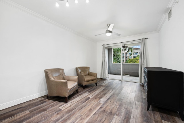 sitting room featuring ceiling fan, ornamental molding, and dark hardwood / wood-style flooring