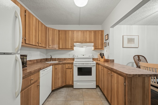 kitchen with light tile patterned floors, sink, white appliances, a textured ceiling, and kitchen peninsula