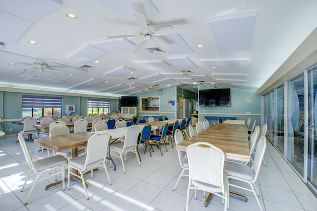 tiled dining space featuring lofted ceiling and ceiling fan