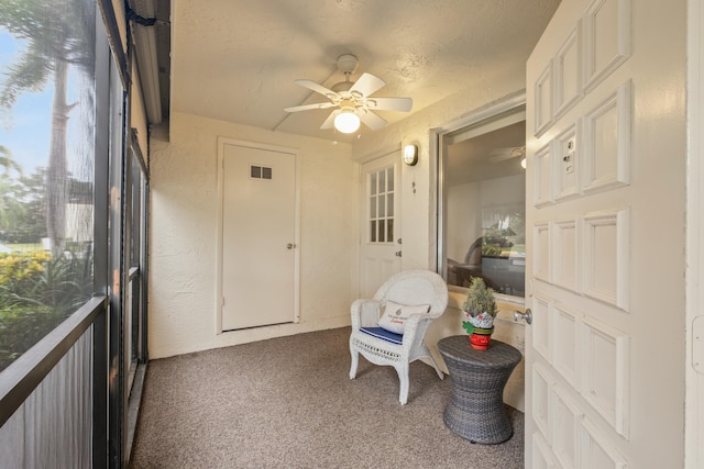 sunroom featuring ceiling fan