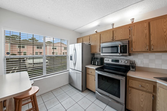 kitchen featuring stainless steel appliances and backsplash