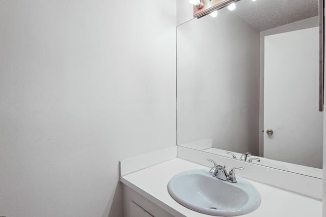 bathroom with vanity and a textured ceiling