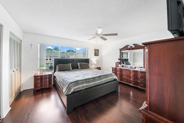 bedroom with a textured ceiling, a closet, ceiling fan, and dark hardwood / wood-style flooring