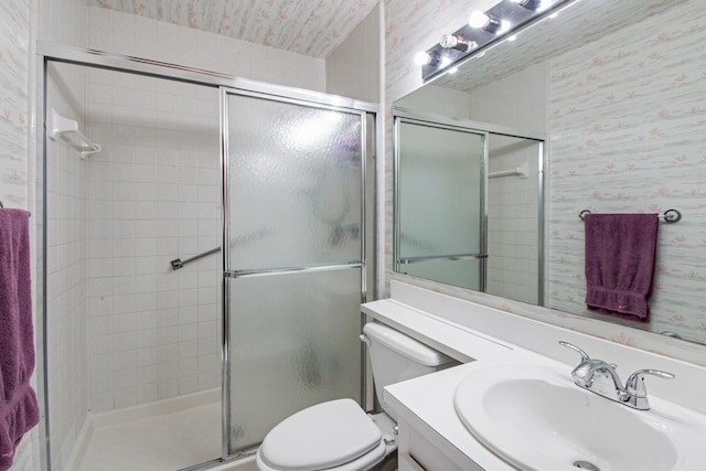 bathroom featuring vanity, toilet, and an enclosed shower