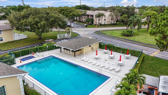 view of swimming pool with a patio area and a yard