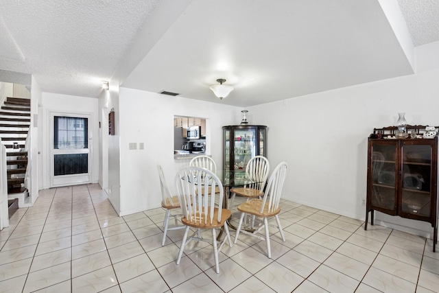 dining area featuring a textured ceiling