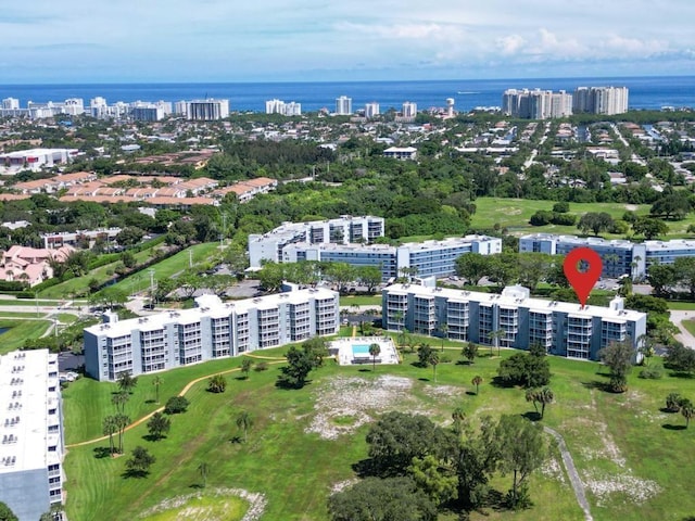 drone / aerial view with a water view and golf course view