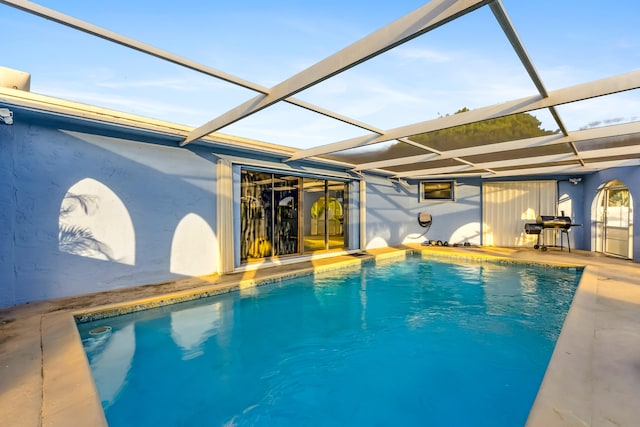 view of swimming pool with a lanai and a patio