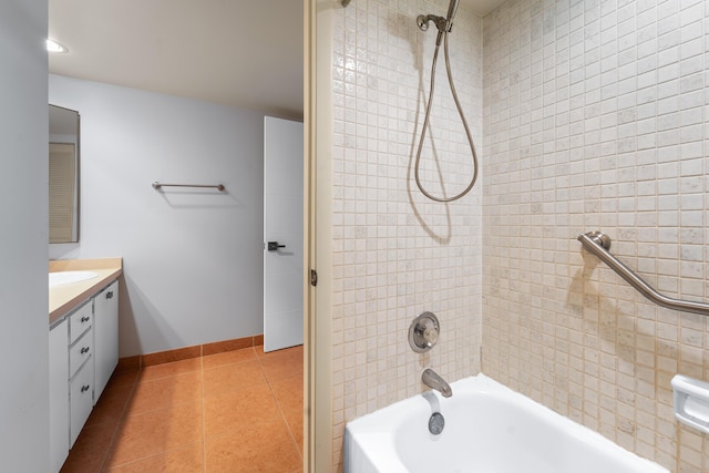 bathroom with tile patterned floors, vanity, and tiled shower / bath