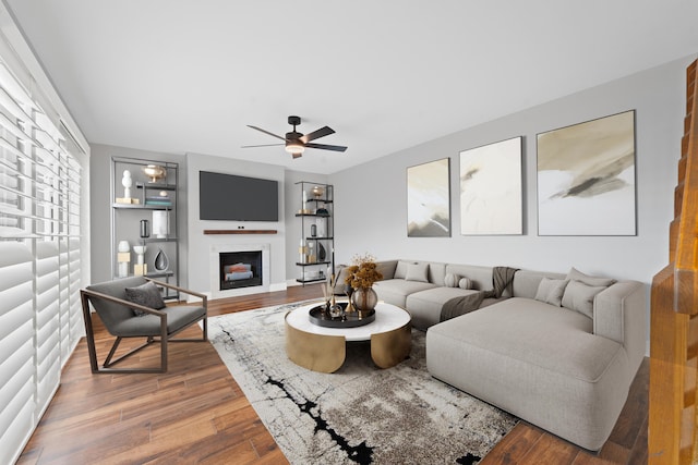 living room featuring hardwood / wood-style floors and ceiling fan