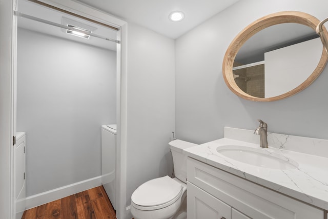 bathroom with vanity, hardwood / wood-style floors, and toilet