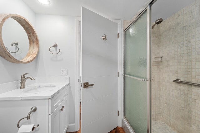 bathroom featuring vanity and a shower with shower door