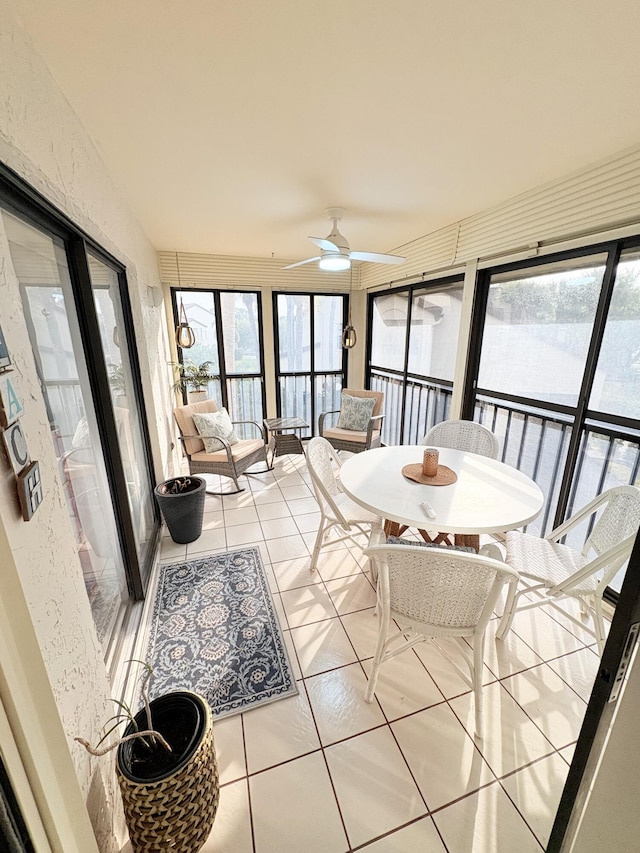 sunroom / solarium with ceiling fan and a healthy amount of sunlight