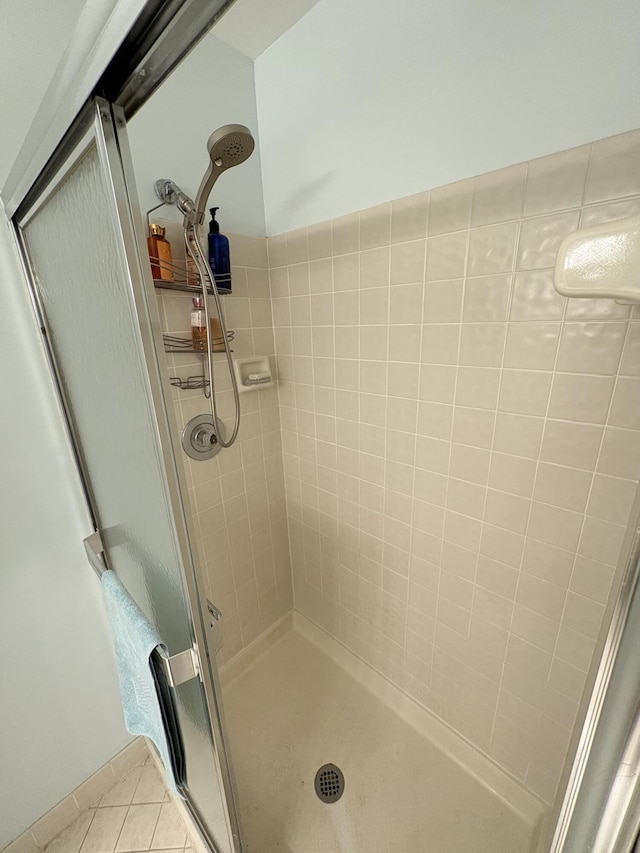 bathroom featuring tile patterned flooring and a shower with shower door