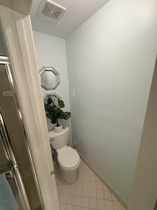 bathroom with tile patterned flooring and toilet