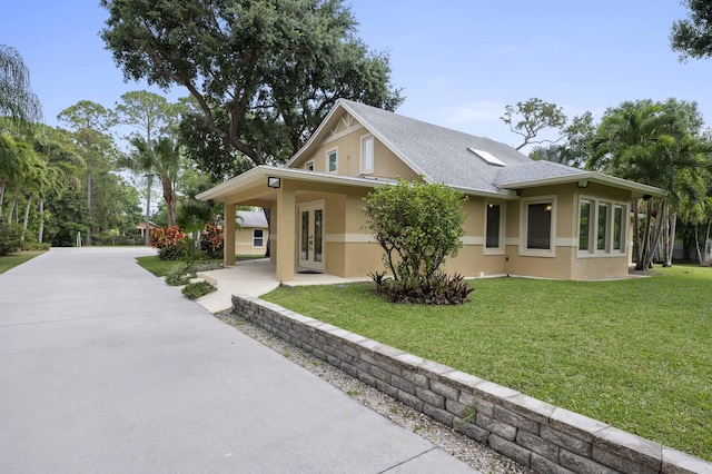 view of property exterior featuring a lawn and a carport