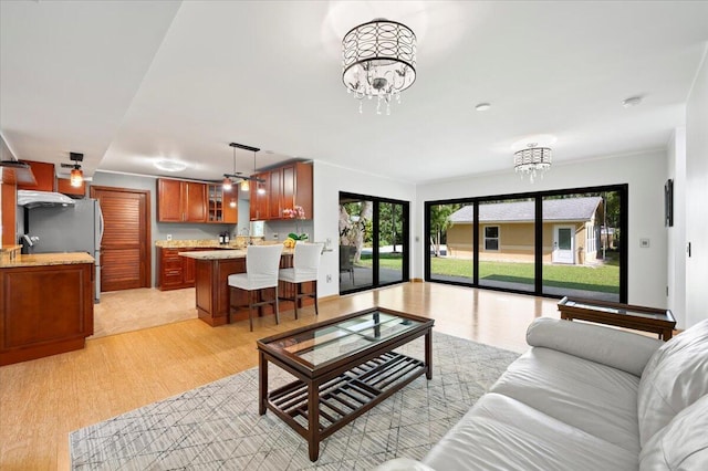 living room featuring a notable chandelier and light hardwood / wood-style floors