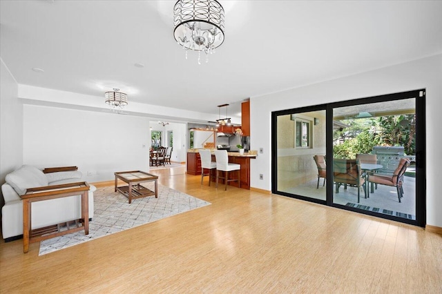 living room featuring a notable chandelier and light hardwood / wood-style floors