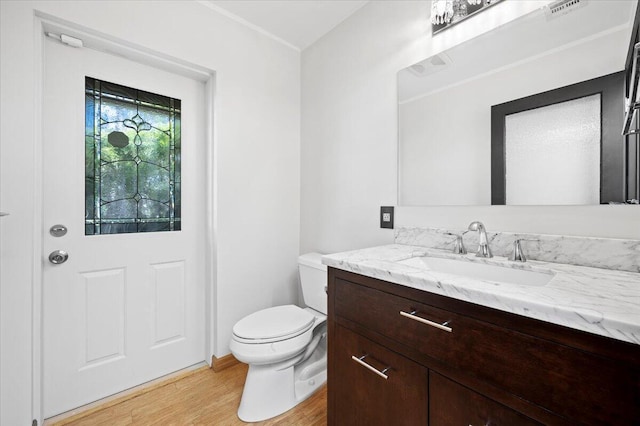 bathroom with vanity, hardwood / wood-style floors, and toilet