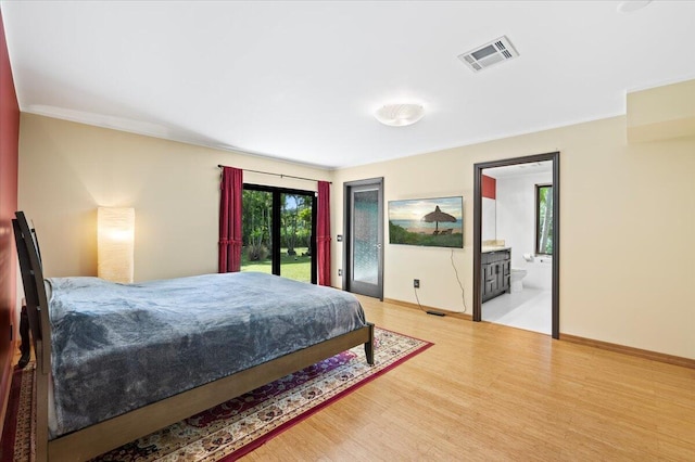 bedroom featuring ornamental molding, access to exterior, ensuite bathroom, and light wood-type flooring