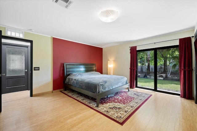 bedroom with access to outside, ornamental molding, and wood-type flooring