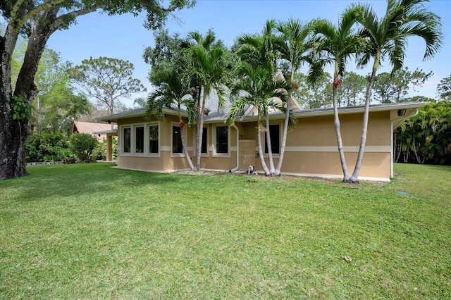 rear view of house with a lawn