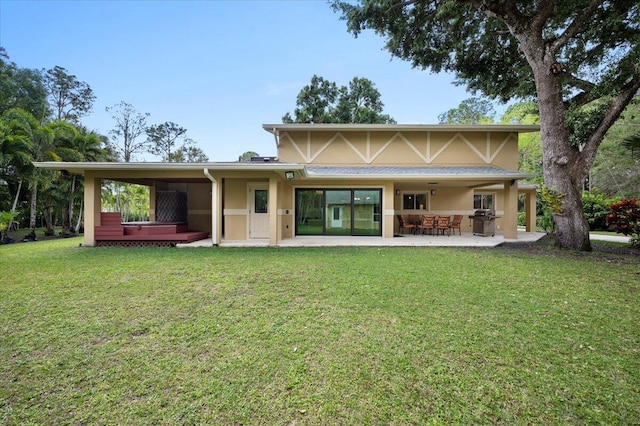 back of house featuring a yard and a patio area