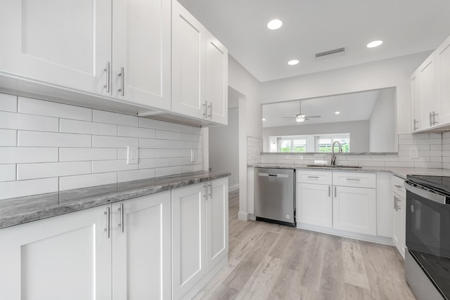 kitchen featuring ceiling fan, sink, white cabinetry, light stone countertops, and stainless steel appliances