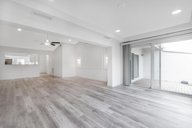 unfurnished living room with vaulted ceiling, ceiling fan, and light hardwood / wood-style floors