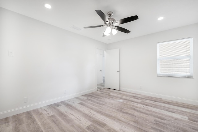 spare room with light hardwood / wood-style floors and ceiling fan