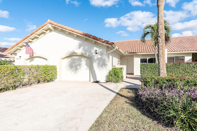 mediterranean / spanish-style home featuring a garage