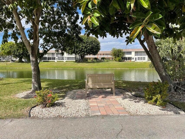 view of community featuring a water view and a lawn