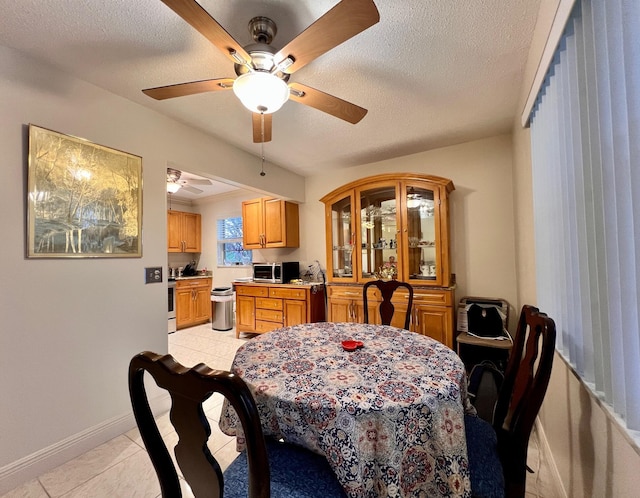 dining area with light tile patterned floors and a textured ceiling