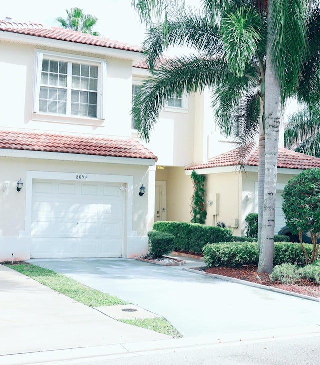 mediterranean / spanish-style home with a garage