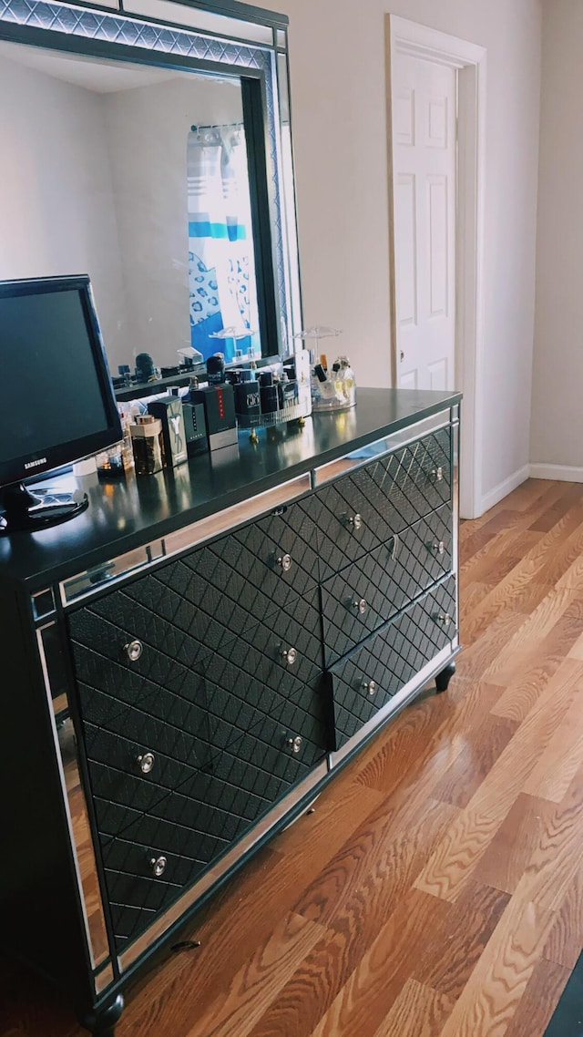 interior space featuring baseboards and wood finished floors