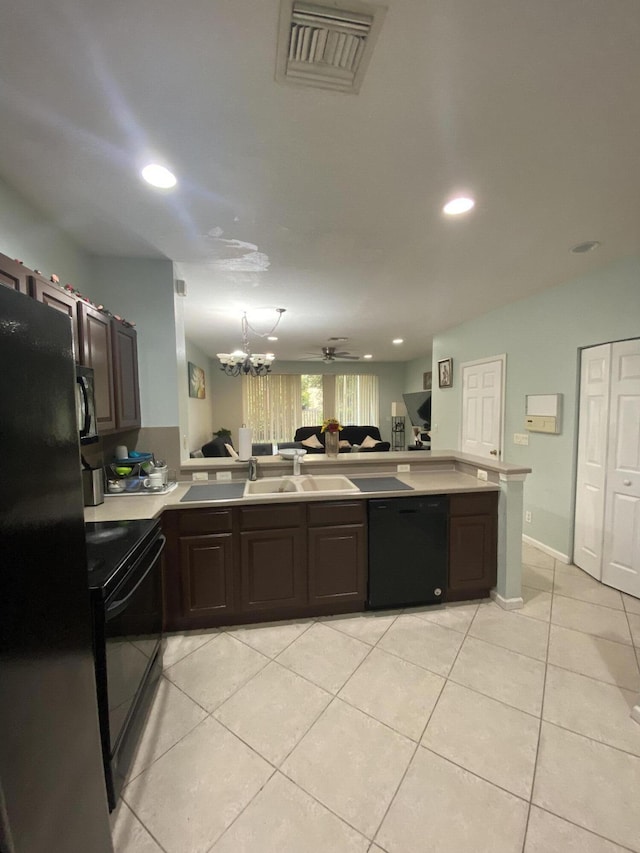 kitchen with light tile patterned floors, kitchen peninsula, dark brown cabinets, ceiling fan with notable chandelier, and black appliances