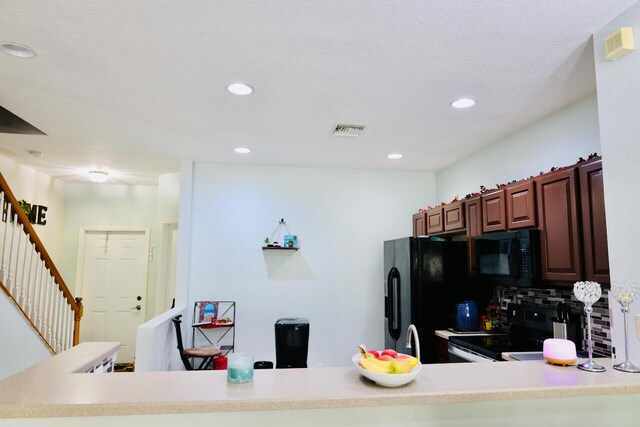 kitchen featuring sink, decorative backsplash, and black appliances