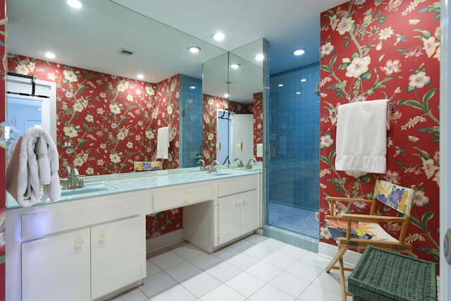 bathroom with tile patterned flooring, a shower with shower door, and vanity