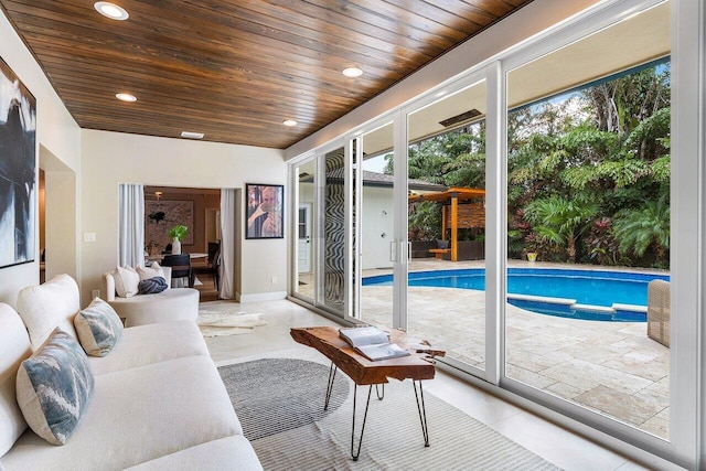 living room with wood ceiling and light tile patterned flooring