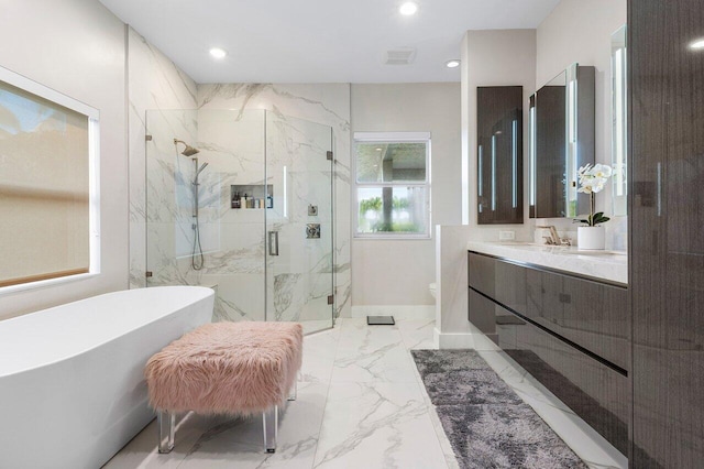 full bathroom featuring vanity, separate shower and tub, and toilet