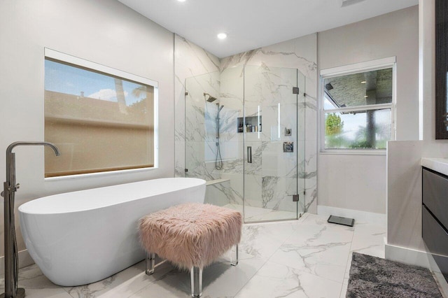 bathroom featuring vanity and separate shower and tub