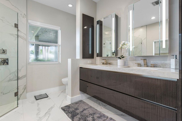 bathroom with toilet, vanity, and a shower with shower door