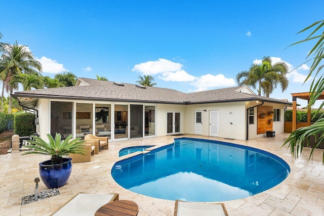 view of swimming pool with french doors, a patio, and an in ground hot tub