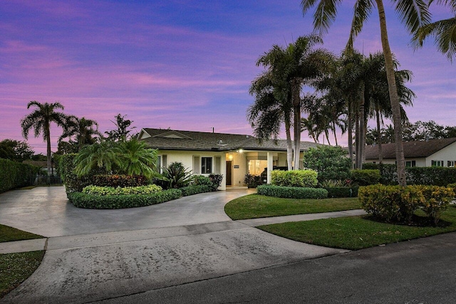 ranch-style home featuring a yard