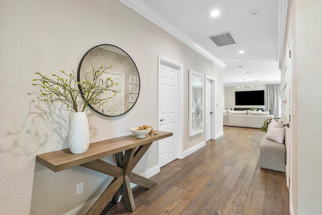 corridor featuring crown molding and dark hardwood / wood-style floors