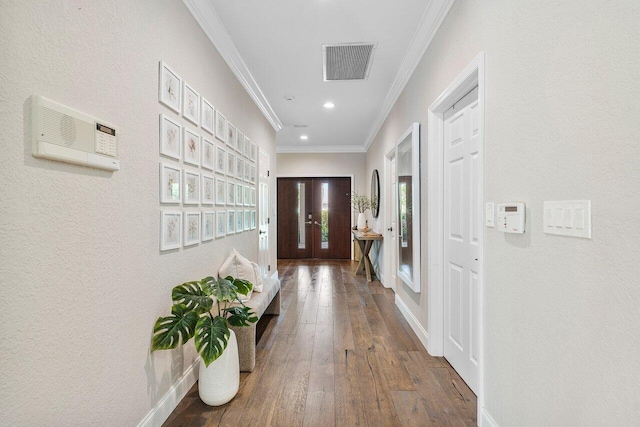 interior space featuring crown molding, dark hardwood / wood-style floors, a wall unit AC, and french doors